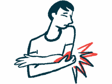 A man winces in pain as he holds his elbow.