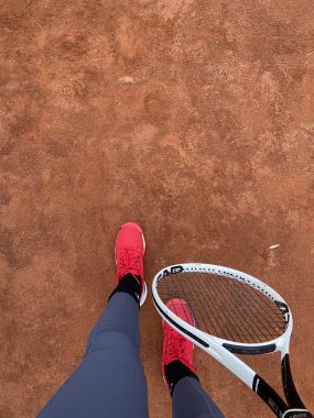 sports and epidermolysis bullosa | Epidermolysis Bullosa News | A photo looking down shows Lena's legs, feet, and a tennis racket.