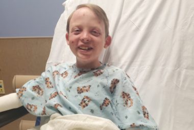 oral surgery and EB | Epidermolysis Bullosa News | Jonah smiles from a postoperative hospital bed.