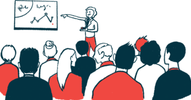 A speaker points to longitudinal data on a whiteboard while giving a presentation.