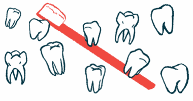 Several teeth of different shapes and sizes float in front of a large red toothbrush
